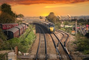 Picture of train travelling along tracks at sunset