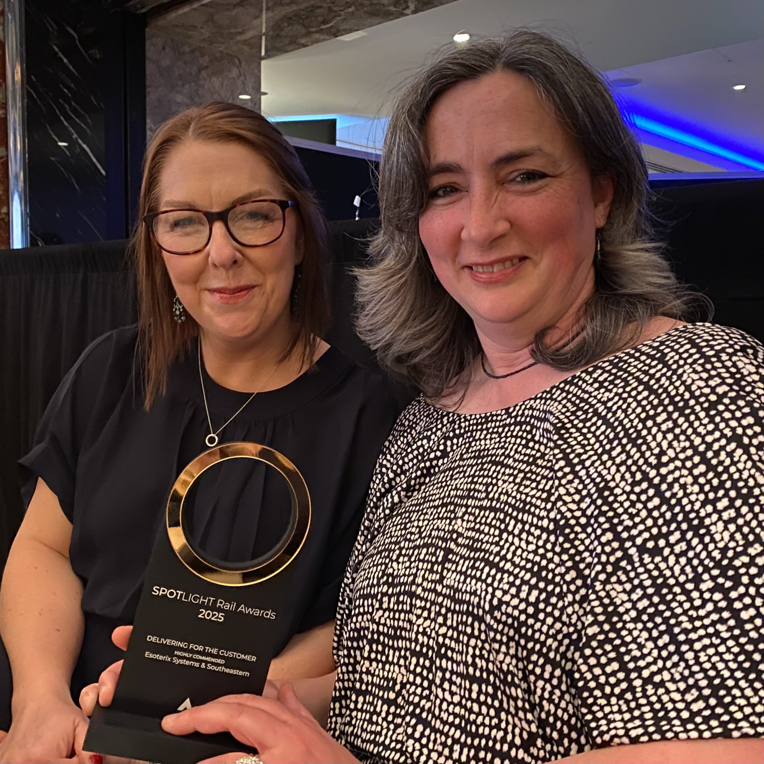 Photo of Astrid Agnew and Liz Davidson holding the Highly Commended trophy at the Spotlight Rail Awards ceremony